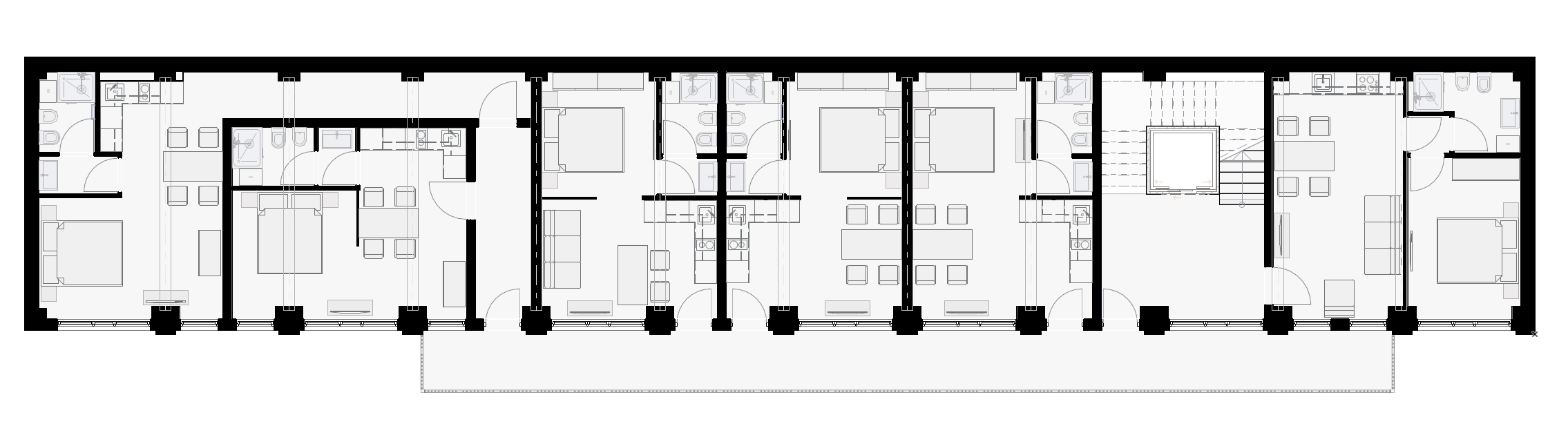 First floor plan with compact residential units accessed through external gallery. Planimetria del primo piano con unità residenziali compatte accessibili da ballatoio esterno.