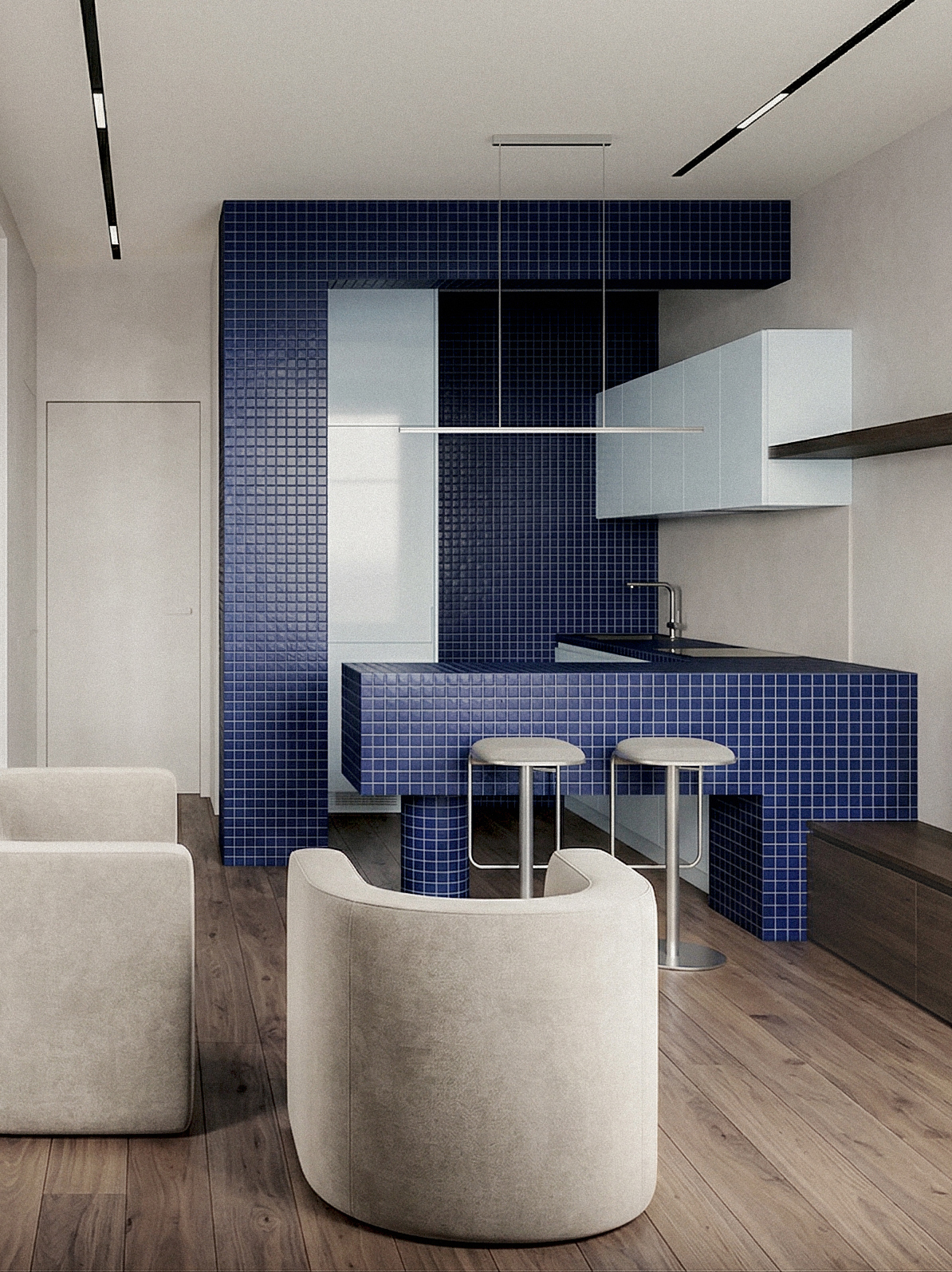 Cucina aperta con isola e rivestimento in mosaico blu, integrata nello spazio principale dell’appartamento. Open kitchen with island and blue mosaic finish, integrated into the apartment’s main living space.