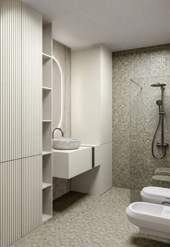 Bagno compatto con mosaico chiaro, arredi sospesi e sistemi di contenimento integrati. Compact bathroom with light mosaic surfaces, suspended furniture and integrated storage.